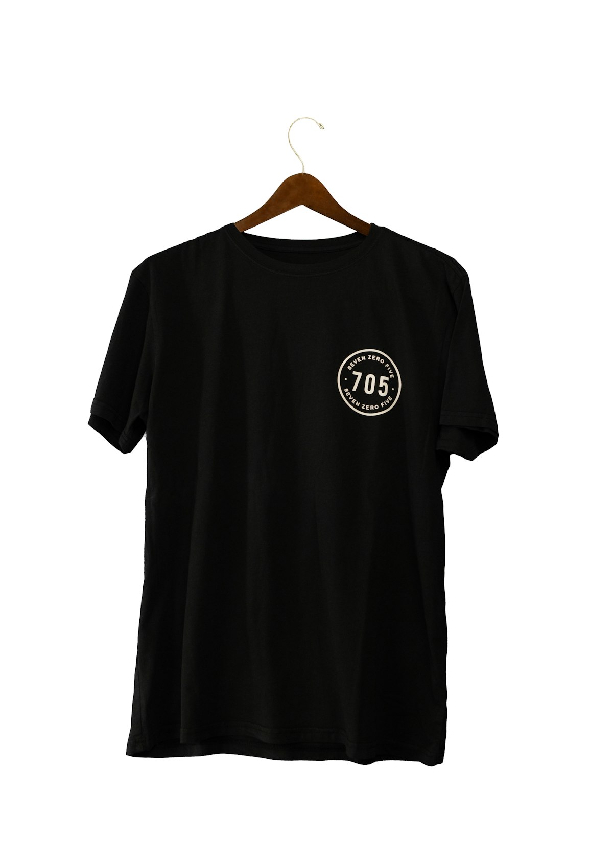 Black graphic T-shirt on a wooden hanger against a white background — image 1 of 2